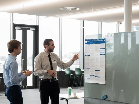 A mixed CIDS and partner team working through a project together around one table.