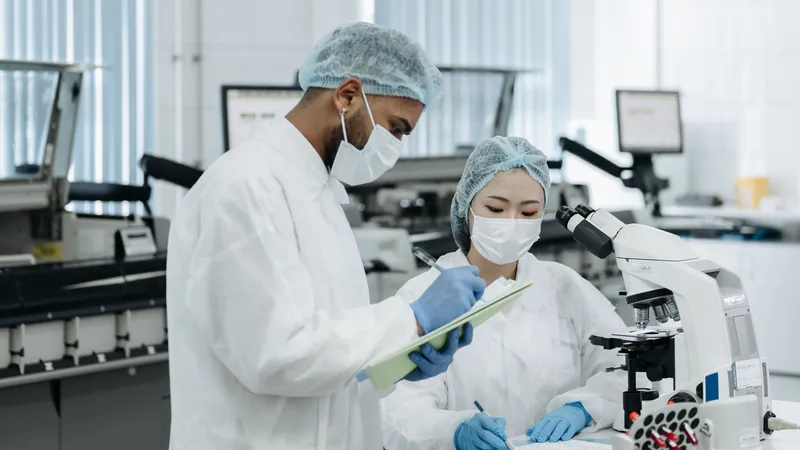 Researchers reading plots together at a dual-monitor workstation.